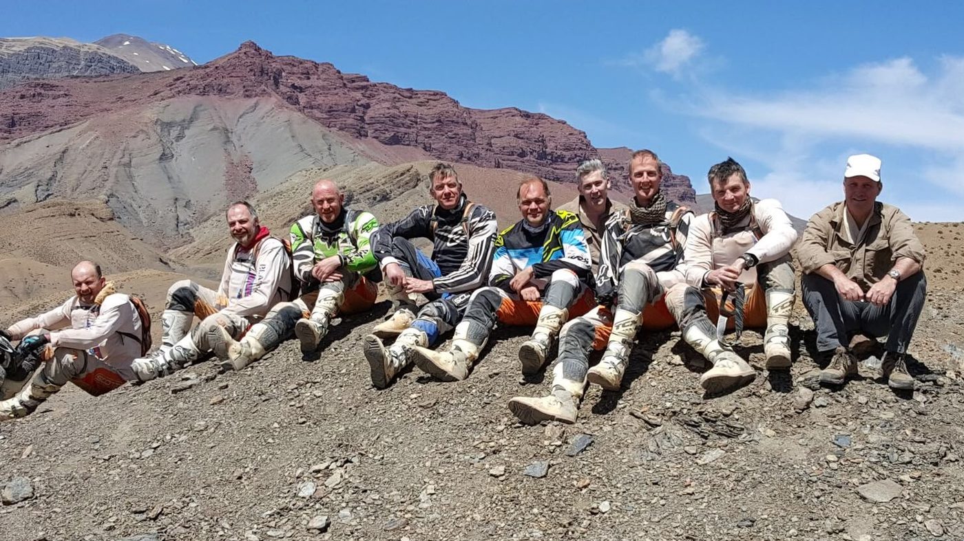 The team resting on rocks in the Tanzanian bush